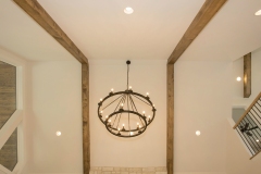 Custom home great room with cathedral ceiling white oak beams