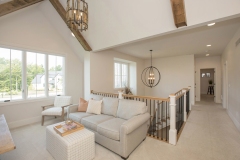 loft or bonus room with cathedral ceiling overlooking staircase