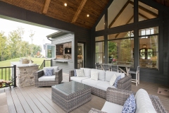 Custom home covered porch cathedral ceilings and stone fireplace and pass through window and grilling station