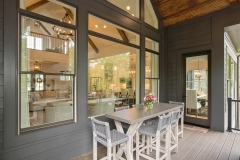 Custom home covered porch with cathedral ceiling and dining area