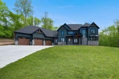 Bear Creek Exterior with Green Siding, Stone and Cedar Accents