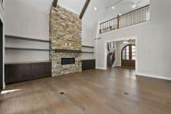 Vaulted Ceiling in Great Room With Stone Fireplace