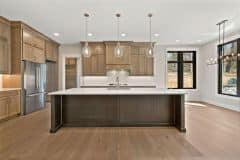 Custom Kitchen With Stained Cabinetry, Quartz Countertops and Hidden Pantry