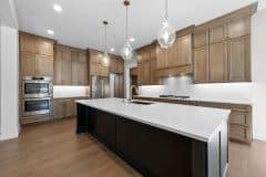 Wood Stain Cabinetry and Black Island at Bear Creek