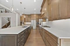 Wood Stained Kitchen Cabinetry With Black Island