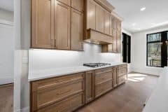 Wood Stained Kitchen Cabinetry To Ceiling