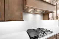 Custom Wood Stained Hood with Slab Backsplash