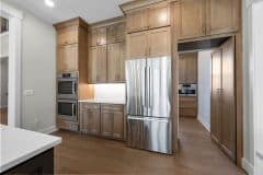 Appliance Wall and Hidden Pantry In Custom Home Kitchen
