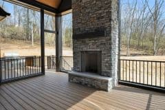 Bear Creek Stone Fireplace Inside Covered Screened In Porch with Custom Grilling Station