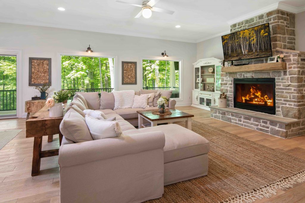living room with stone fireplace and couch