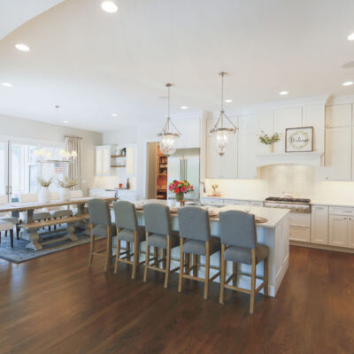 Kitchen with White Custom Cabinetry and Large Island with Seating