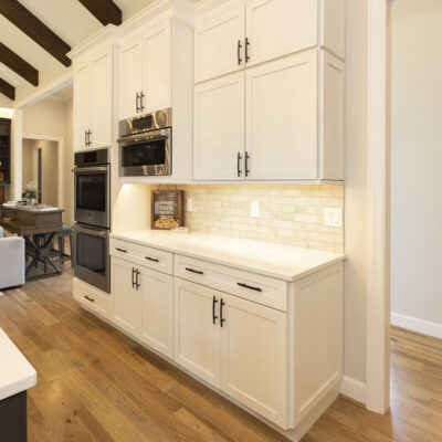 White Custom Kitchen Cabinets with Stone Backsplash