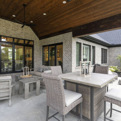 Covered Outdoor Living Space with Stone Fireplace off Great Room and Kitchen