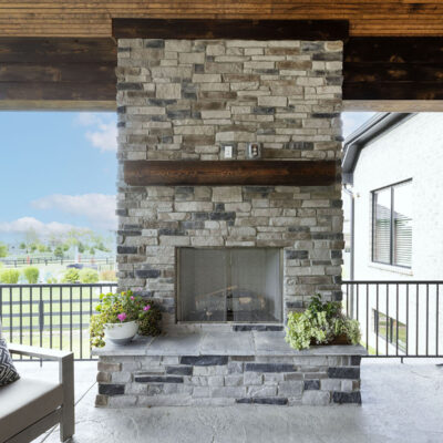 Covered Outdoor Living Space with Stone Fireplace