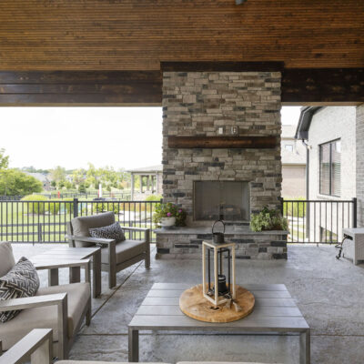 Covered Outdoor Living Space with Stone Fireplace