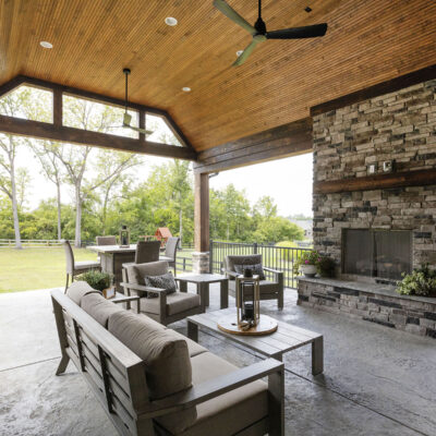 Covered Outdoor Living Space with Stone Fireplace and Bead Board Ceiling