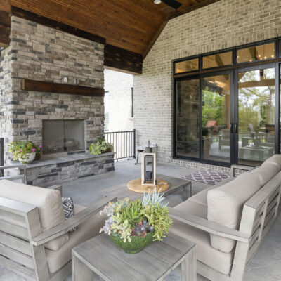 Covered Outdoor Living Space with Stone Fireplace off Great Room and Kitchen