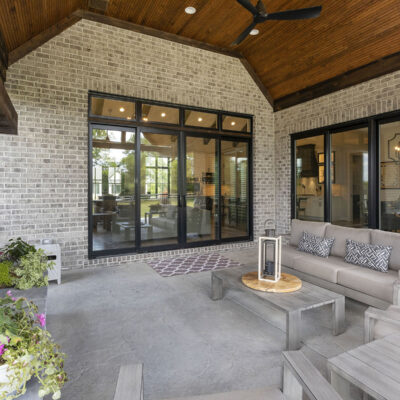 Covered Outdoor Living Space with Stone Fireplace off Great Room and Kitchen