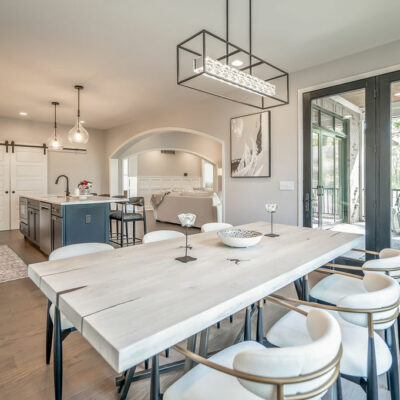 Modern Kitchen with Large Island and Dining Area with Walk-out to Screened Porch