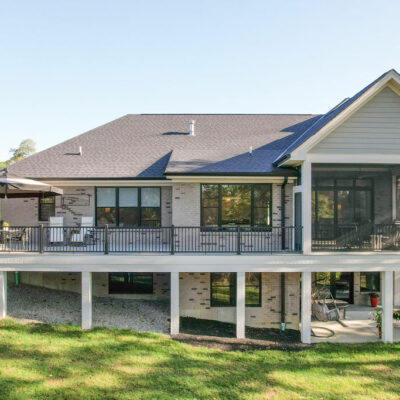 Back of Home with Large Porch with a Partial Screen-In Porch and Wrapped Hardie Pillars