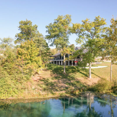 Back of Home with Large Porch with a Partial Screen-In Porch with Pond View