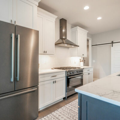 Modern Kitchen with Large Island and Sliding Barn Door Pantry