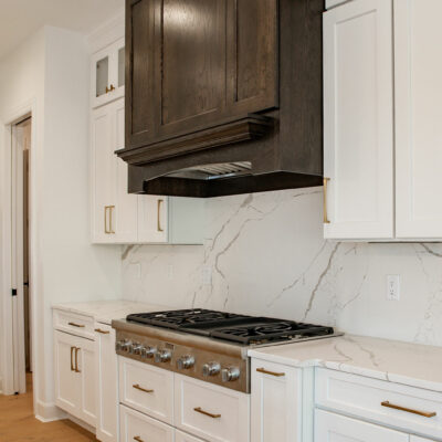 Kitchen Hood and Range with Quartz slab backsplash