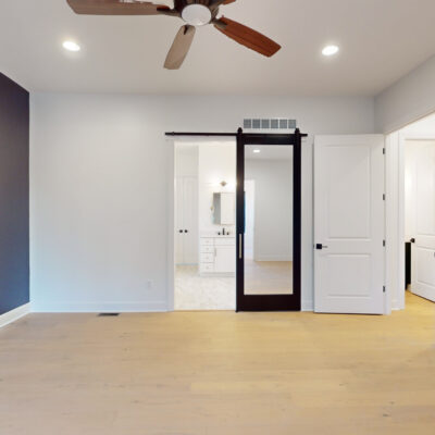 Primary Bedroom with Sliding Glass Barn Door to Bathroom