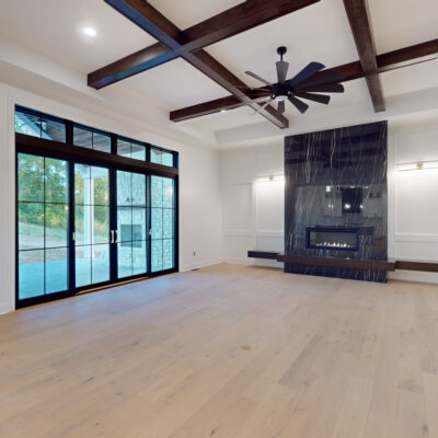 Great Room with Ceiling Beams and Linear Marble Fireplace