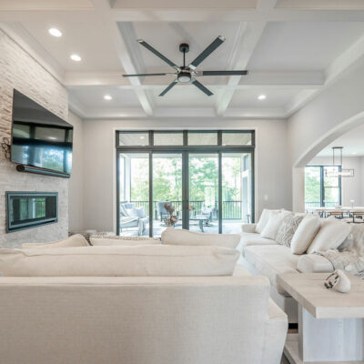 Modern Great Room with Coffered Ceiling, Arched Cased Openings and Walk-out to Screened-In Porch