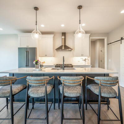 Modern Kitchen with Large Island and Sliding Barn Door Pantry