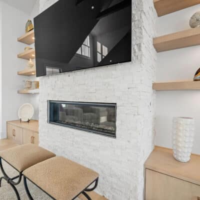 Stack Stone Fireplace with Floating Open Shelving in Great Room