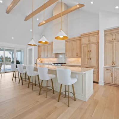 Kitchen with 2 cabinet colors and large island and backsplash using Taj Mahal granite