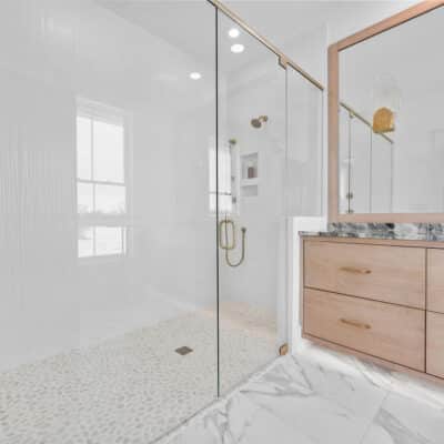Secondary Full Bath With Floating White Oak Vanity and Custom Framed Mirror, Curbless Shower With Gold Accents