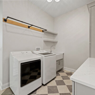 Laundry With Custom Cabinetry Farmhouse Sink