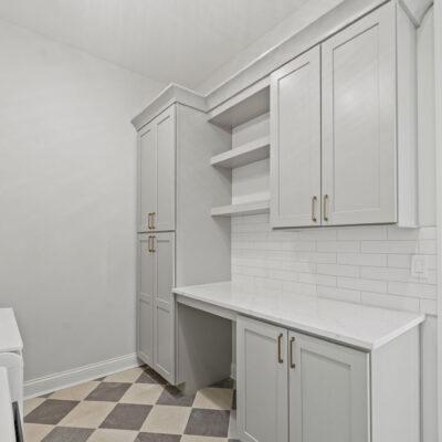 Laundry With Custom Cabinetry Farmhouse Sink