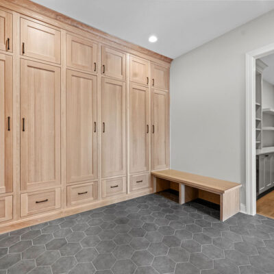 Mudroom with floor-to-ceiling white oak custom cabinetry