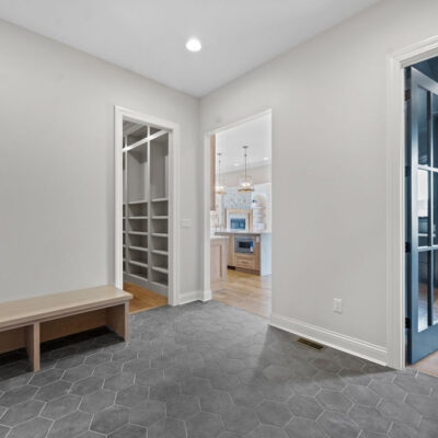 Mudroom with floor-to-ceiling white oak custom cabinetry