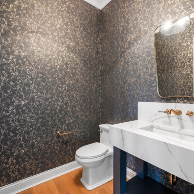 Powder Room With Wall Mount Faucet and Gold Accents