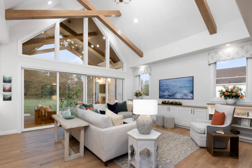 Great Room with cathedral ceiling and white oak cross beams carried through to outdoor covered rear porch.