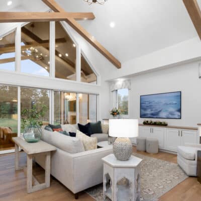 Great Room with cathedral ceilings an white oak cross beams carried through to outdoor covered porch