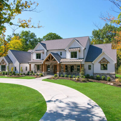 modern farmhouse custom home in liberty township with gables, painted brick, cedar and metal accents