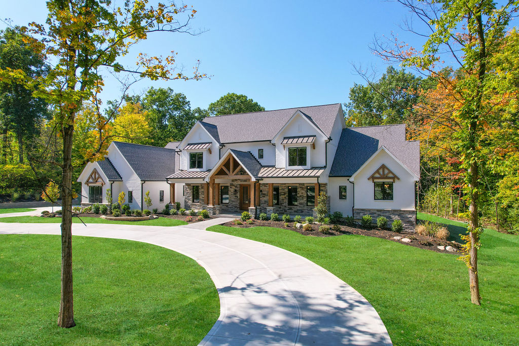 modern farmhouse custom home in liberty township with gables, painted brick, cedar and metal accents
