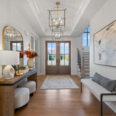 Entry With Tray Ceiling and Two Chandeliers