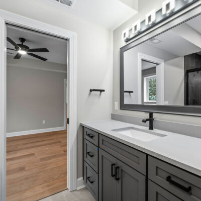 Lower level Bathroom With Custom Cabinetry and Framed Mirror