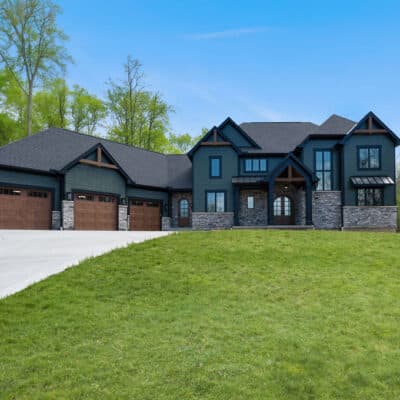 Two Story Custom Home Cleaves Stone Dark Green Siding Stone and Cedar Accents