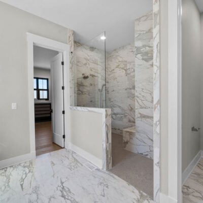 Primary Bathroom Shower With Alustra Imperial Gold Matte Tile 24x48