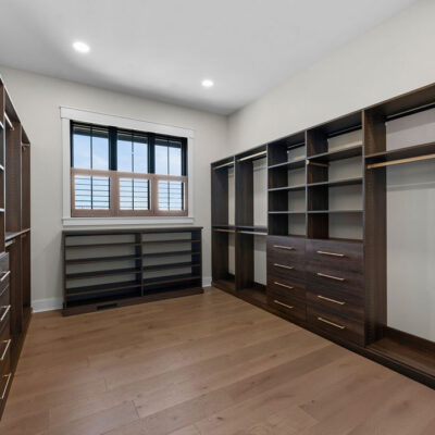Dark Wood Stain Custom Walk-in California Closet with window with black trim