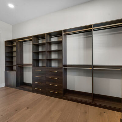 Dark Wood Stain Custom Walk-in California Closet with window with black trim
