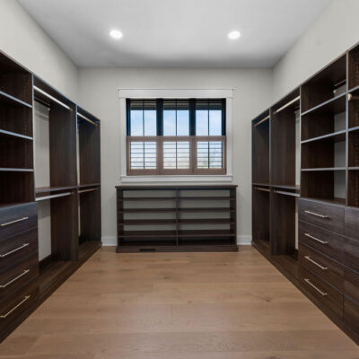 Dark Wood Stain Custom Walk-in California Closet with window with black trim